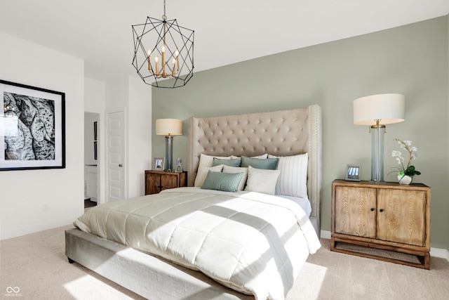 carpeted bedroom with a chandelier and baseboards