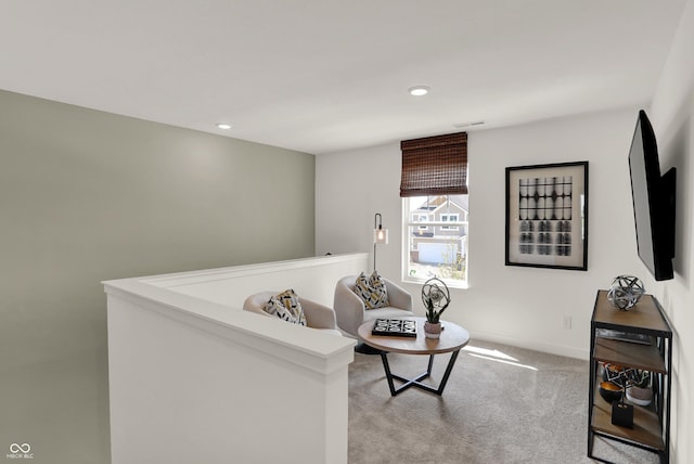 living area with carpet, an upstairs landing, and recessed lighting