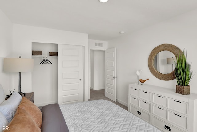 bedroom featuring carpet, a closet, visible vents, and baseboards