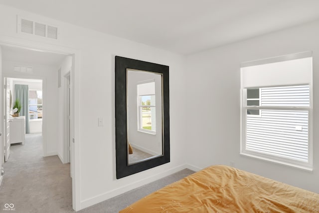 unfurnished bedroom with baseboards, visible vents, and light colored carpet