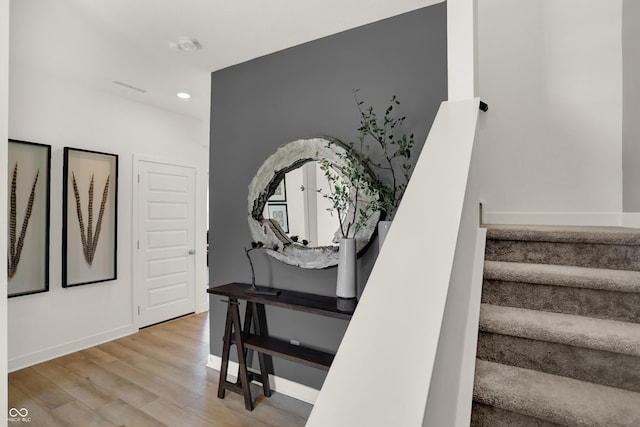 stairs with baseboards, visible vents, wood finished floors, and recessed lighting