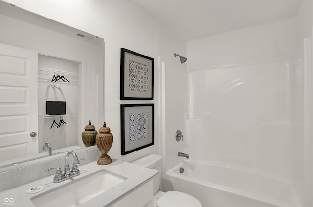 bathroom with visible vents,  shower combination, vanity, and toilet