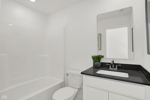 bathroom featuring toilet, washtub / shower combination, and vanity