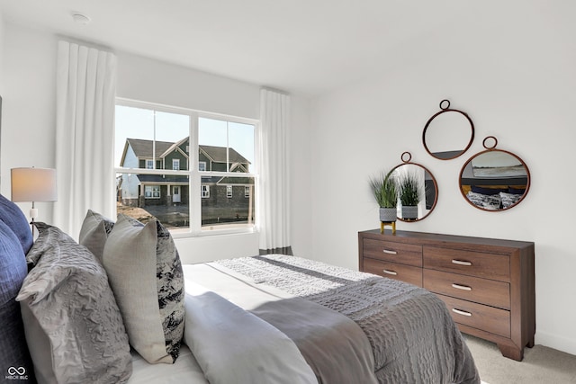 bedroom featuring light carpet