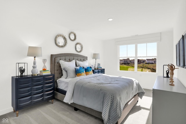 bedroom featuring carpet and baseboards