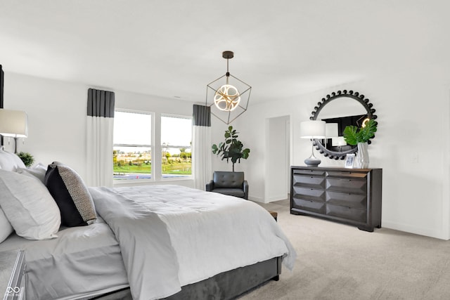 bedroom with a chandelier, light carpet, and baseboards