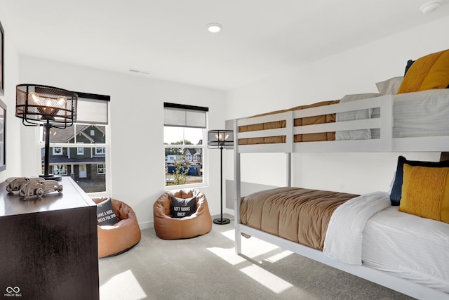 carpeted bedroom with a chandelier and recessed lighting