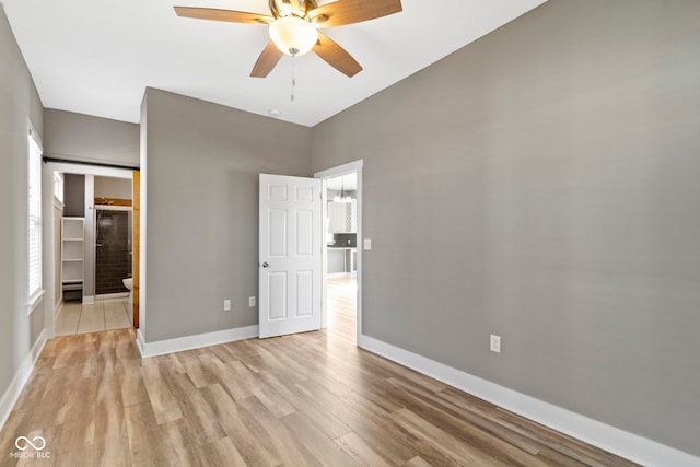 unfurnished bedroom with a ceiling fan, baseboards, and light wood finished floors