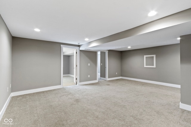 finished basement with recessed lighting, baseboards, and light carpet