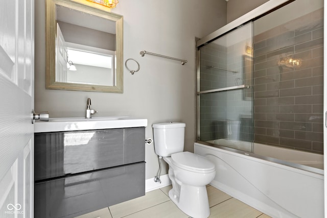 full bath featuring vanity, toilet, and combined bath / shower with glass door