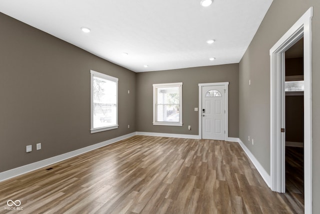 foyer entrance featuring visible vents, recessed lighting, wood finished floors, and baseboards