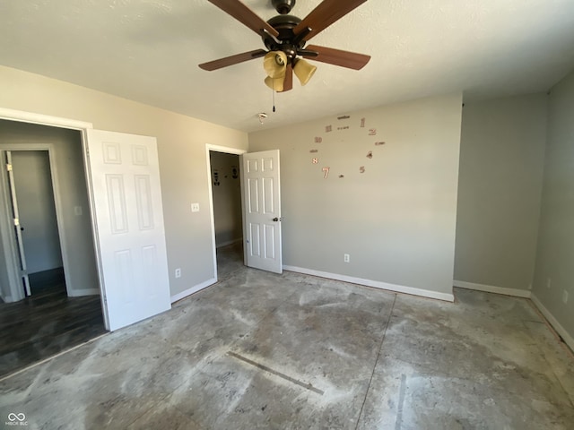 unfurnished bedroom with concrete floors, baseboards, and ceiling fan