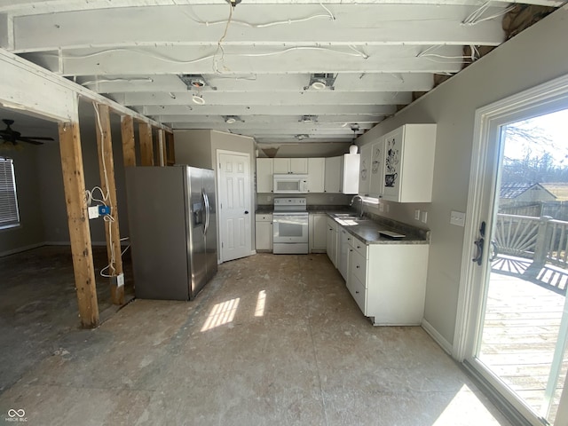 kitchen with white appliances, a sink, white cabinetry, baseboards, and dark countertops