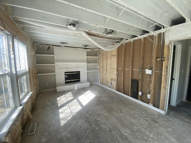 unfurnished living room featuring a fireplace and visible vents