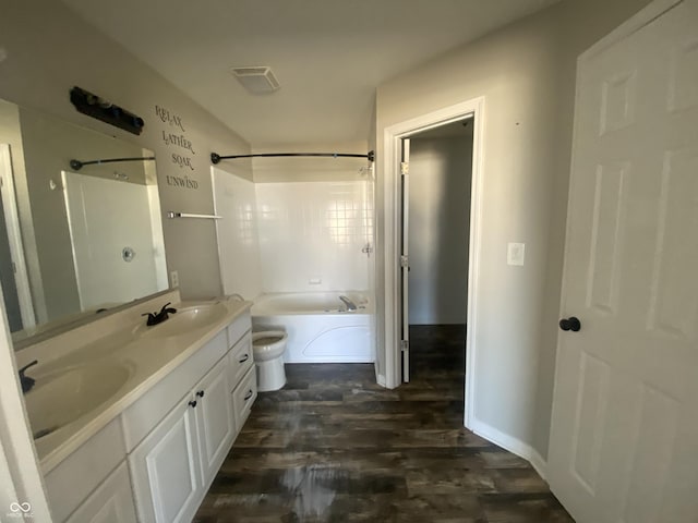 full bathroom featuring visible vents, a sink, toilet, and double vanity