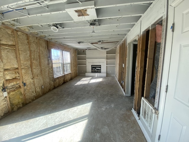 miscellaneous room with a garage, a large fireplace, and visible vents