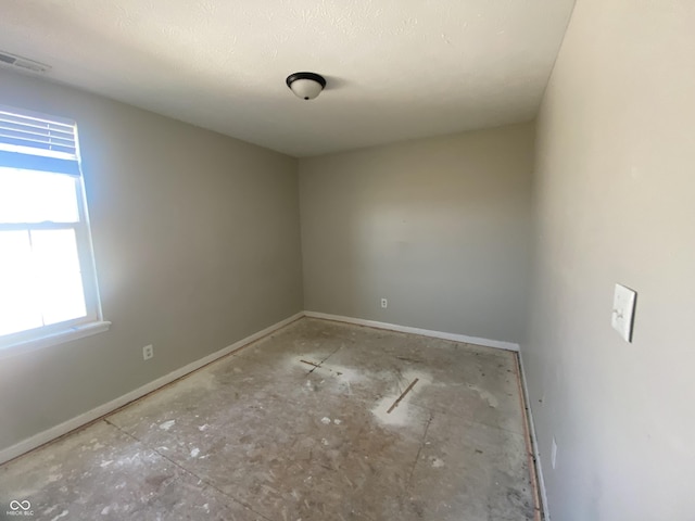 empty room featuring visible vents and baseboards