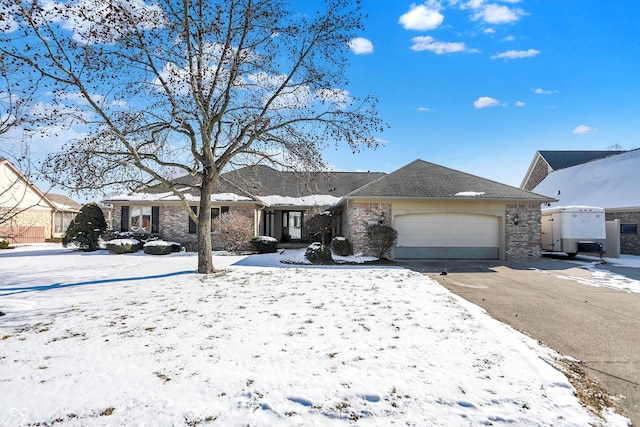 ranch-style home with brick siding, driveway, and an attached garage