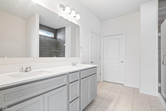 bathroom with double vanity, tile patterned flooring, a sink, and a shower stall