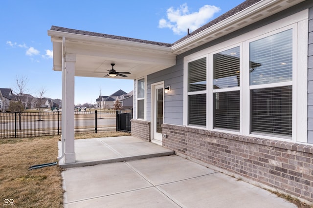 view of patio featuring a residential view, fence, and ceiling fan