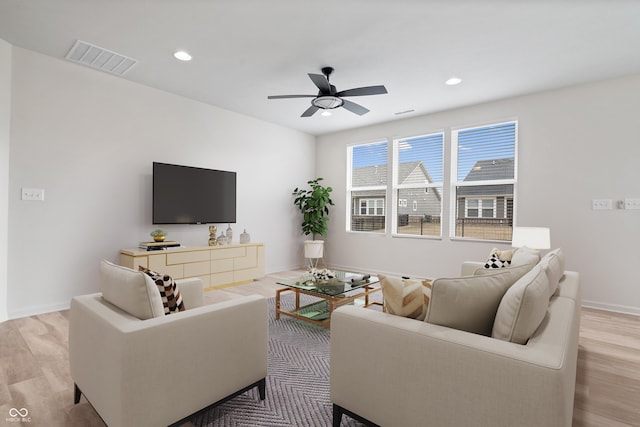 living room with ceiling fan, recessed lighting, visible vents, and light wood-style floors