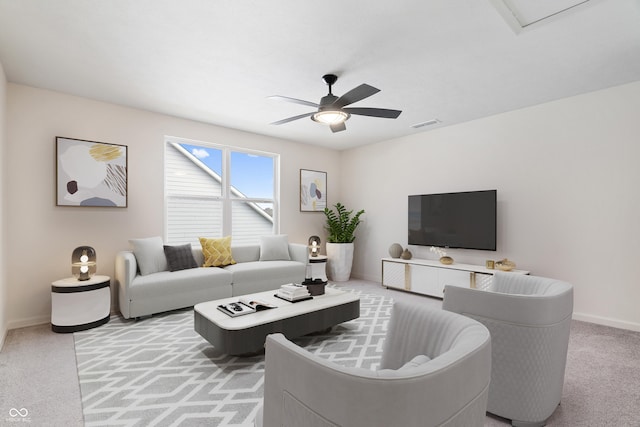 living area featuring ceiling fan, carpet floors, visible vents, and baseboards