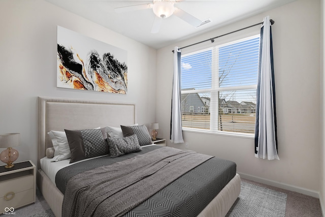 carpeted bedroom with visible vents, ceiling fan, and baseboards