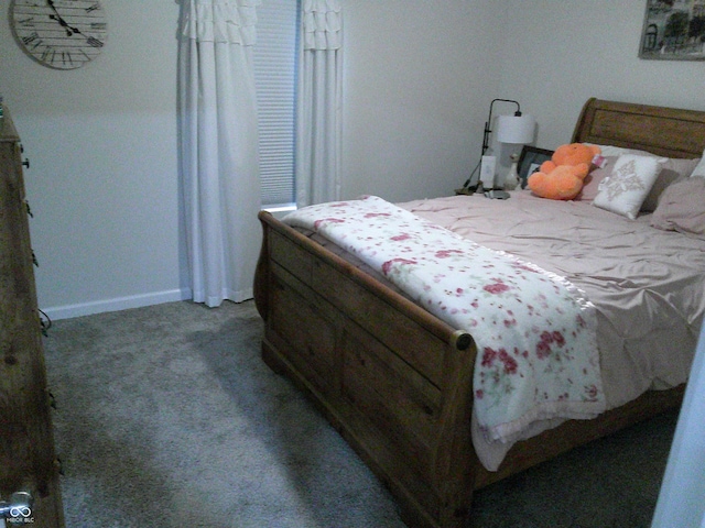 bedroom featuring carpet and baseboards