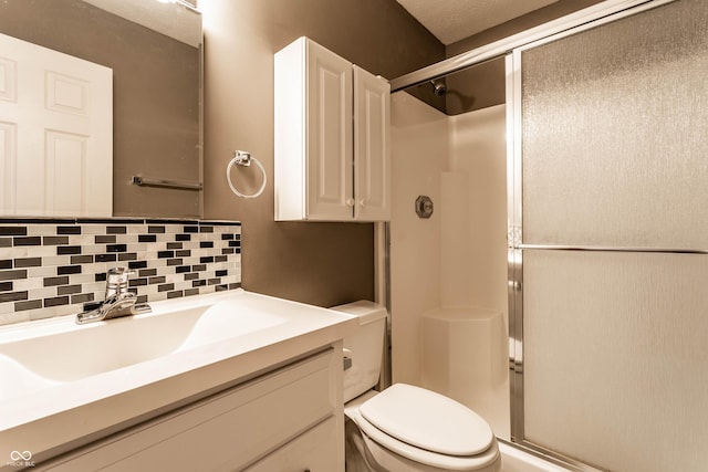 bathroom featuring toilet, tasteful backsplash, a shower stall, and vanity