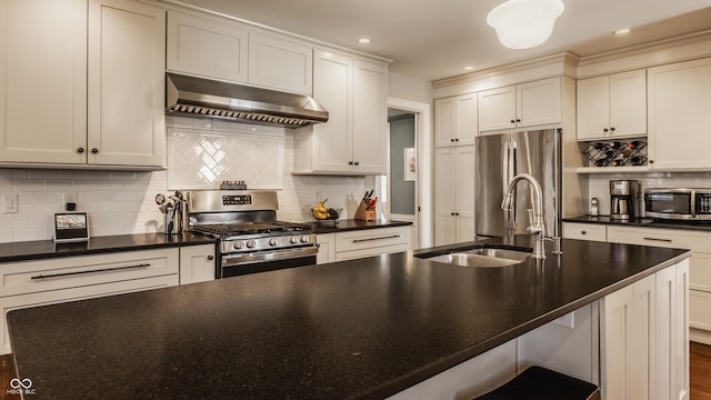 kitchen with stainless steel appliances, ventilation hood, dark countertops, and a sink