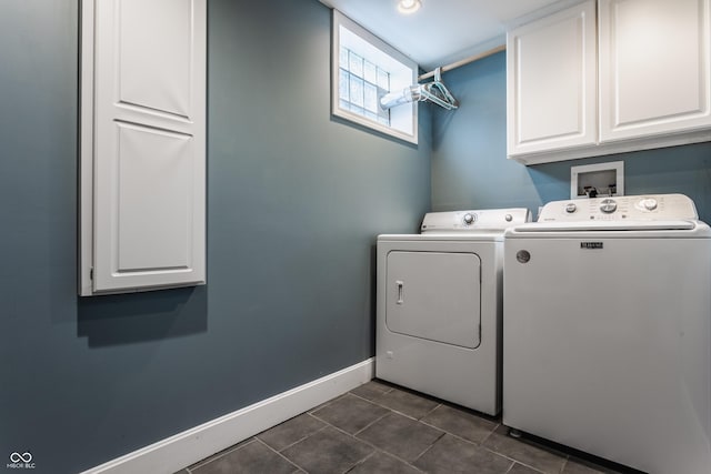 laundry room featuring separate washer and dryer, dark tile patterned floors, cabinet space, and baseboards