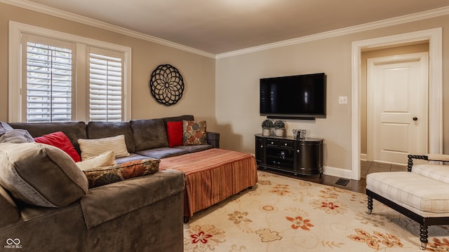 living room featuring ornamental molding, baseboards, and wood finished floors