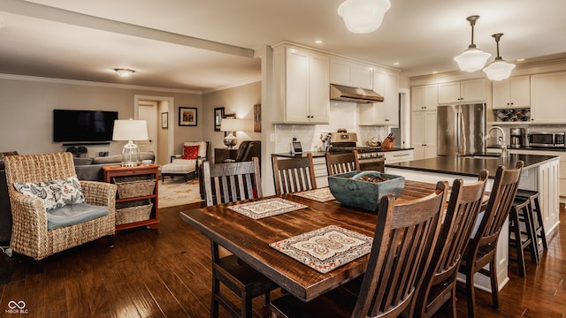 dining room featuring crown molding and dark wood finished floors