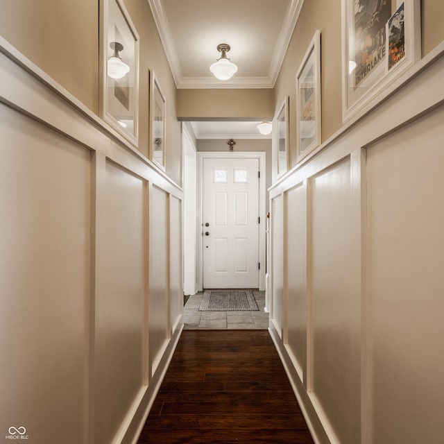 doorway featuring dark wood finished floors and crown molding