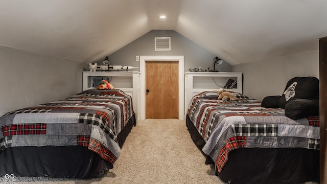 carpeted bedroom featuring lofted ceiling and visible vents