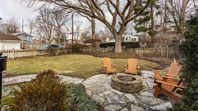 view of yard with an outdoor fire pit, a fenced backyard, and a patio