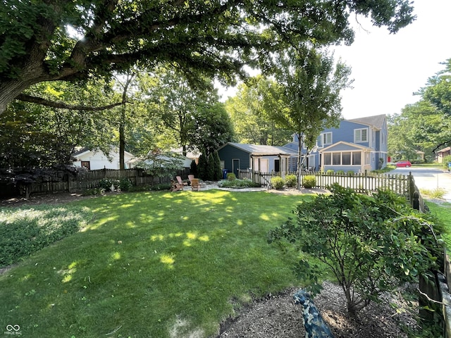 view of yard featuring a sunroom and fence