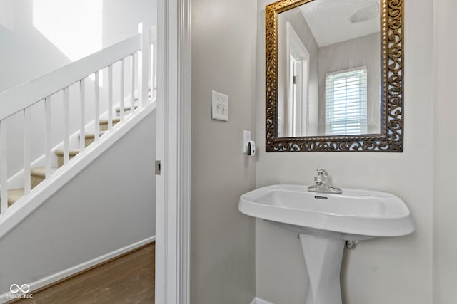 bathroom featuring a sink, baseboards, and wood finished floors