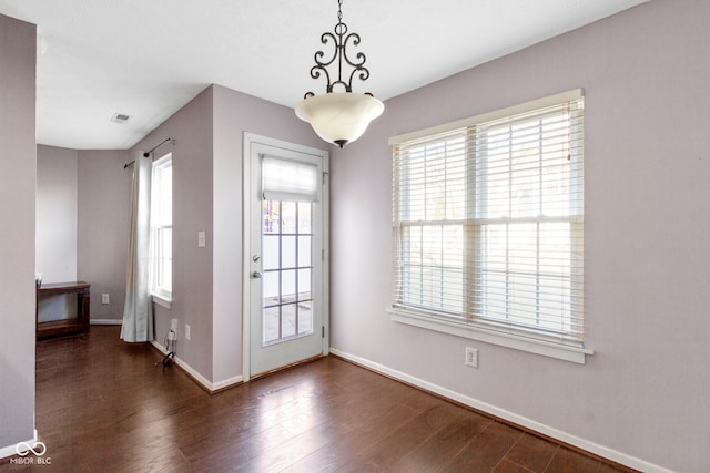 doorway to outside with a healthy amount of sunlight and wood finished floors