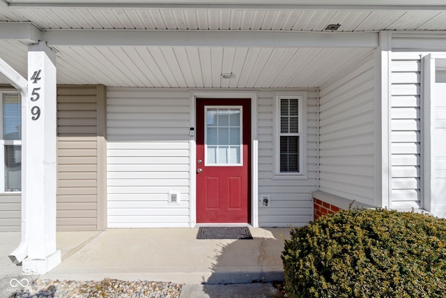 view of exterior entry featuring a porch