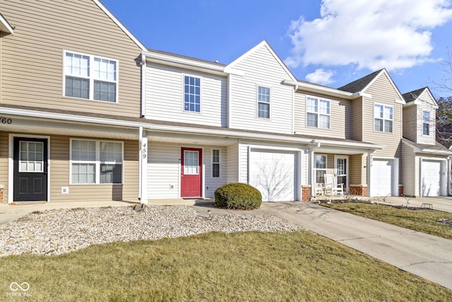 multi unit property with a garage, covered porch, and concrete driveway