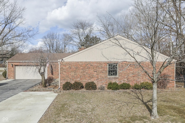 view of property exterior with a garage, brick siding, and aphalt driveway