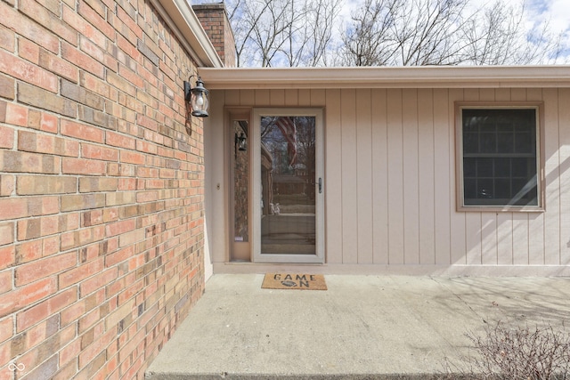 view of exterior entry with brick siding