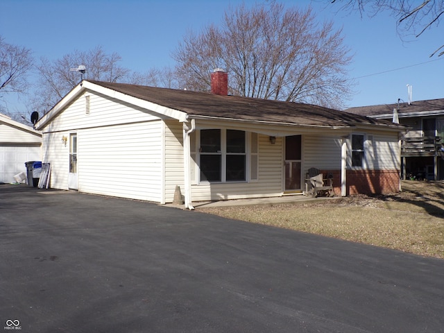 view of front of property with driveway and a chimney