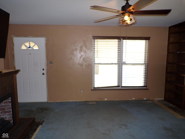 carpeted foyer featuring a fireplace