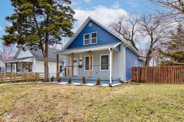 bungalow-style house with a porch, a front lawn, and fence