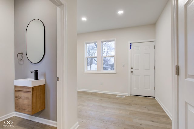 entrance foyer with baseboards, light wood finished floors, and recessed lighting