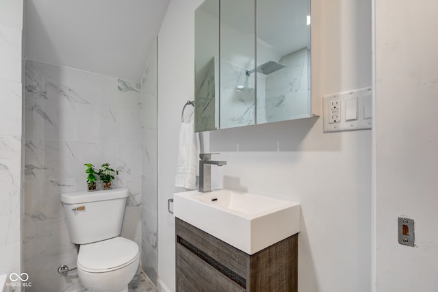 bathroom featuring toilet, tile walls, and vanity