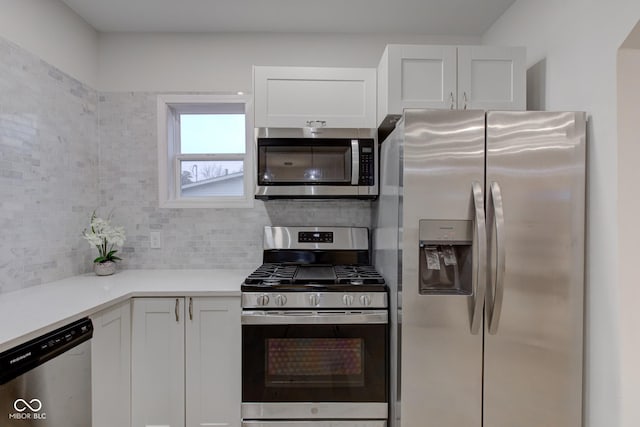 kitchen featuring white cabinetry, appliances with stainless steel finishes, tasteful backsplash, and light countertops