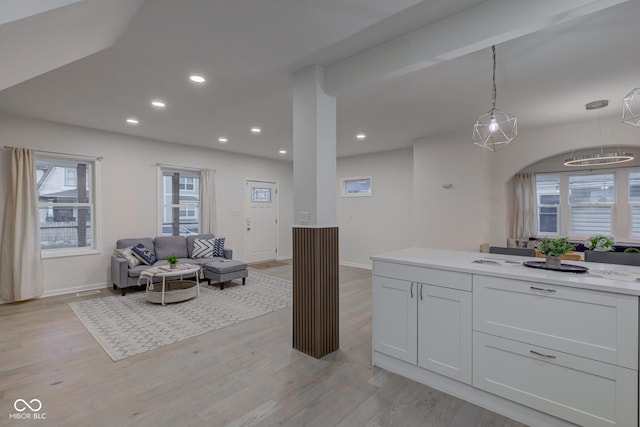 kitchen with light wood-style floors, pendant lighting, light countertops, and recessed lighting